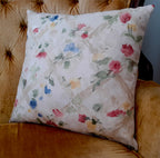 Handmade 18x18 watercolor rose trellis throw pillow cover in blush pink, blue, sage and gold on ivory satin, styled on a gold velvet tufted chair